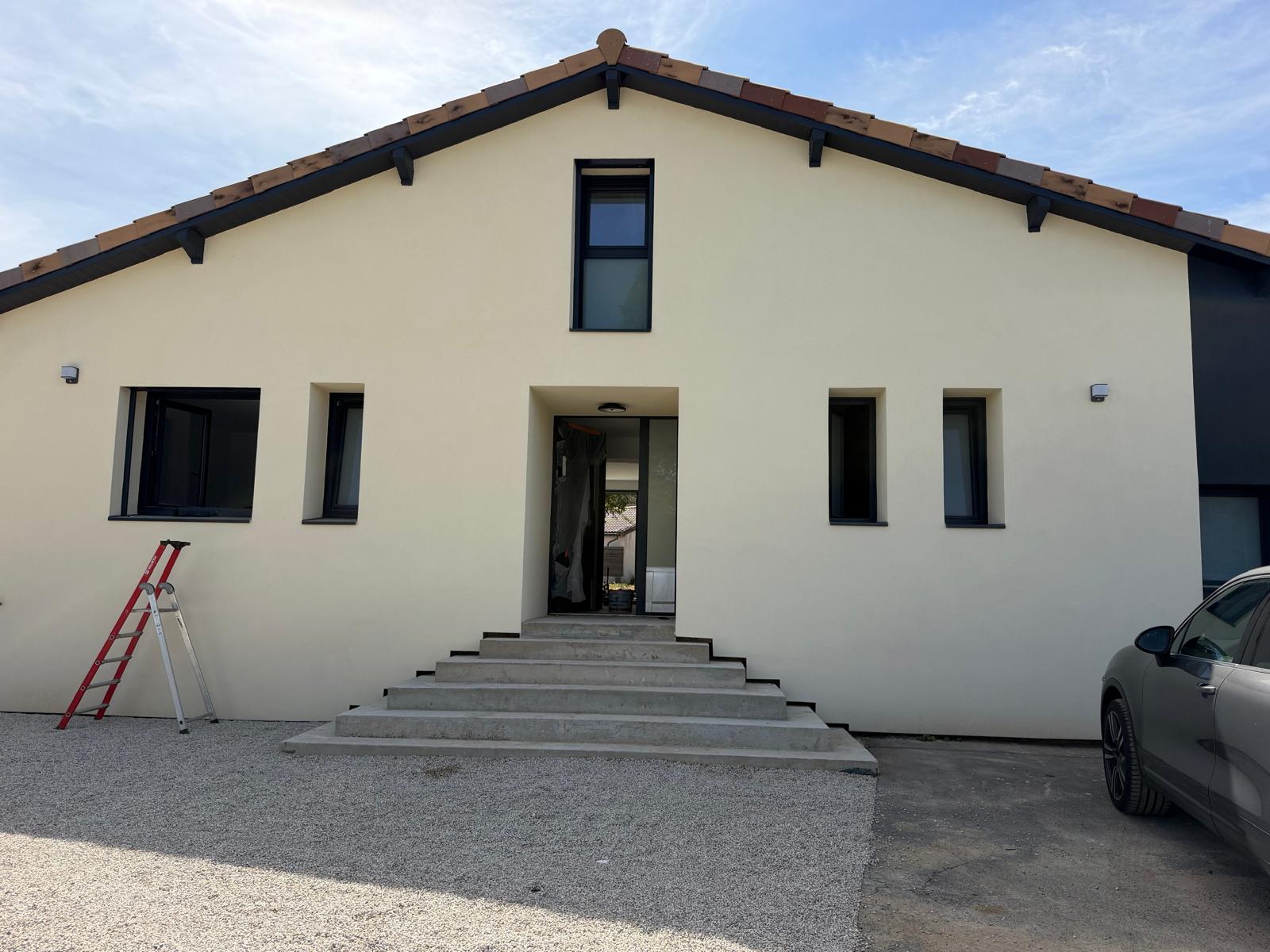 Façade de maison avec fenêtres et porte d'entrée gris anthracite